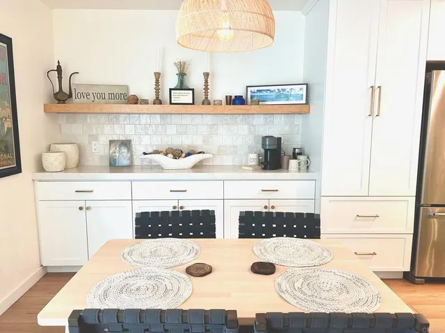 a view of a kitchen with kitchen island a stove a sink and a refrigerator