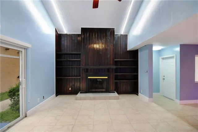 wooden floor in an empty room with a fireplace