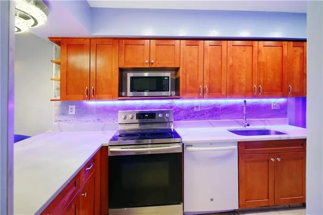 a kitchen with a sink stove and microwave
