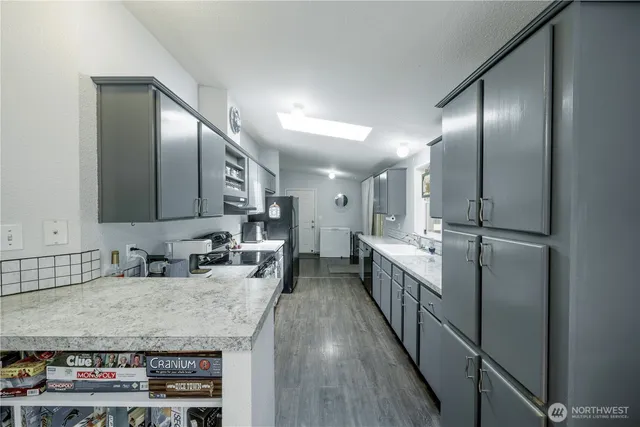 a kitchen with sink cabinets and stainless steel appliances