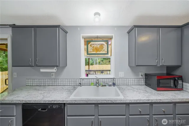 a kitchen with a sink cabinets and window