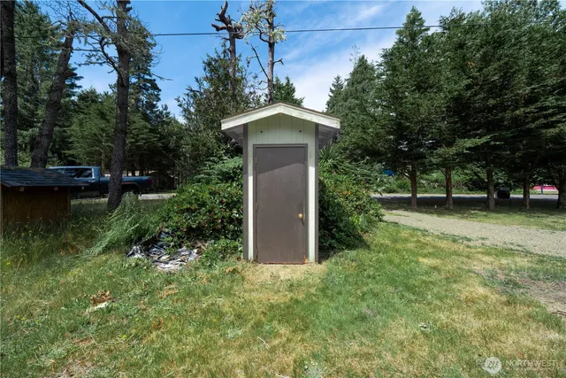 a backyard of a house with lots of green space and fountain