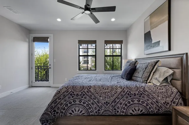 a large bed sitting in a bedroom next to a window
