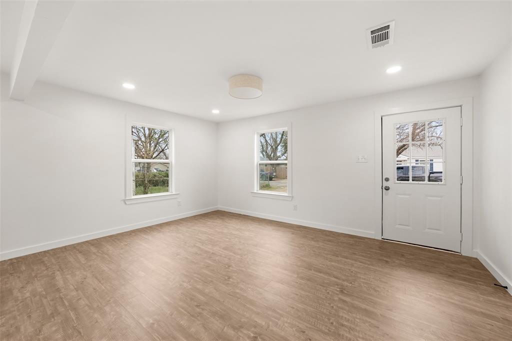 812 Harlem Avenue Waco, TX 76704 - Photo 3 of 16 a view of a big room with wooden floor and windows
