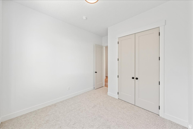 1491 East Centaurus Way, Unit 86 Washington, UT 84780 - Photo 17 of 26 Unfurnished bedroom with a closet and carpet flooring