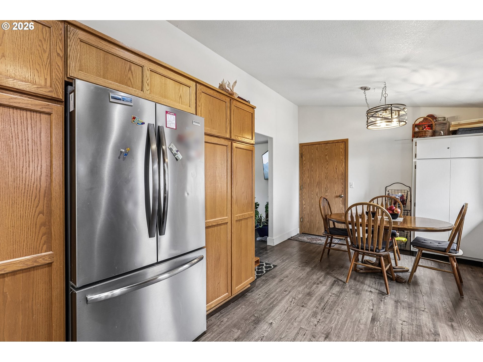 608 Southeast Sumner Street Camas, WA 98607 - Photo 12 of 39 a kitchen with stainless steel appliances refrigerator dining table and chairs