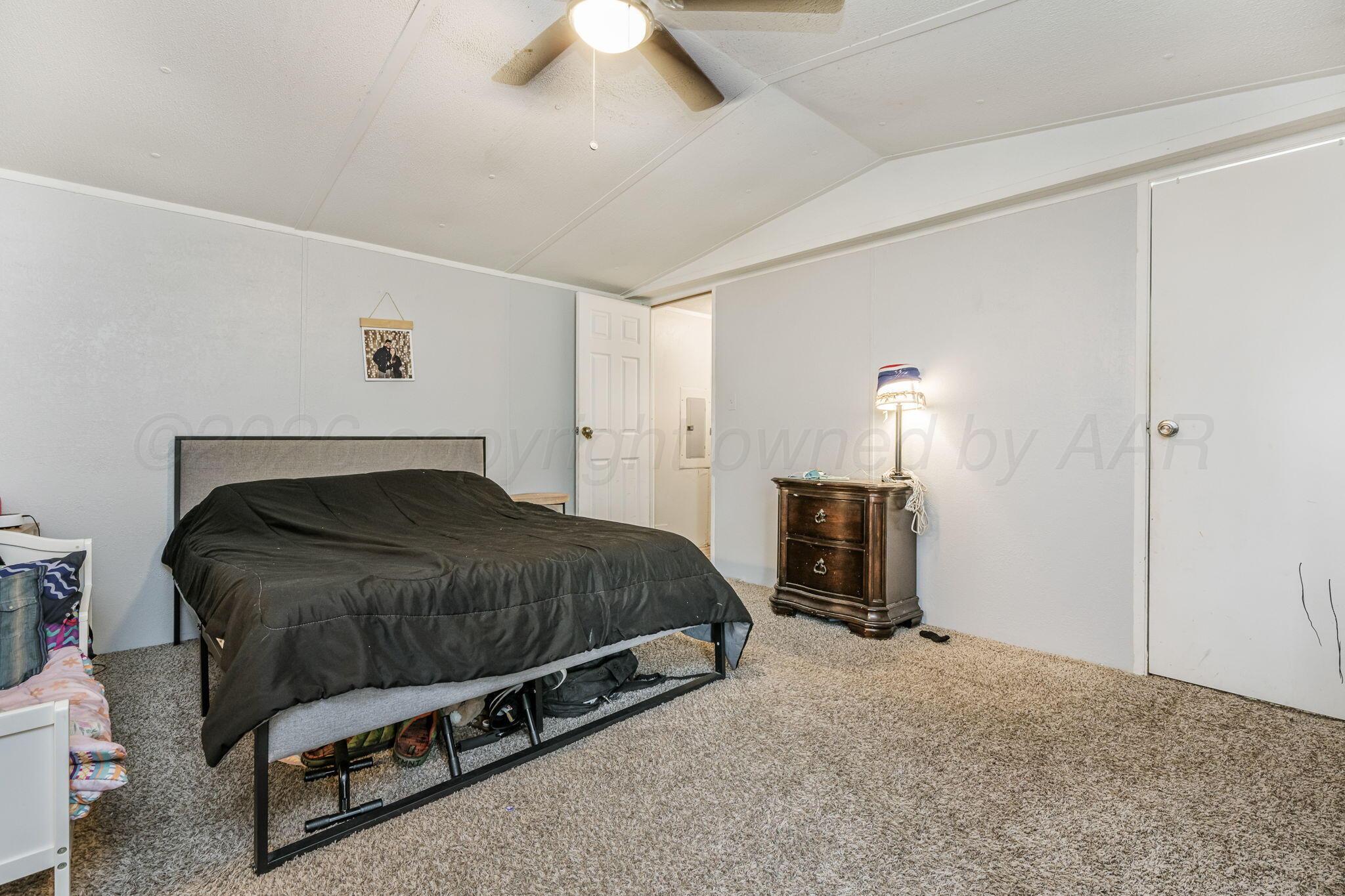 2115 Country Lane Amarillo, TX 79118 - Photo 12 of 15 a bedroom with a bed and a fireplace