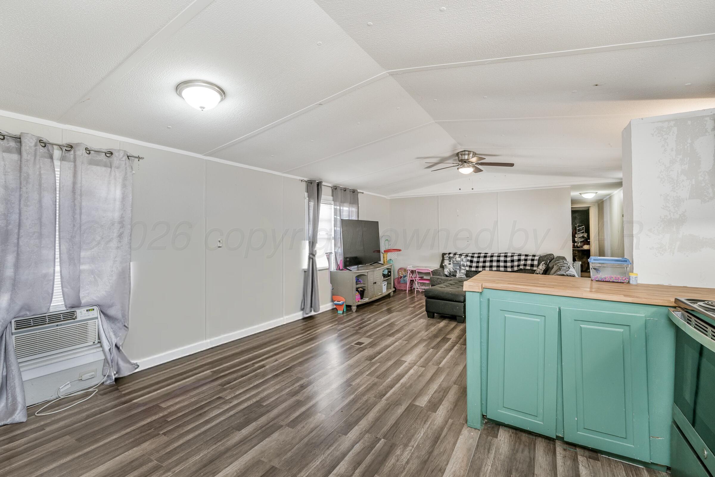 2115 Country Lane Amarillo, TX 79118 - Photo 4 of 15 a living room with furniture and a wooden floor
