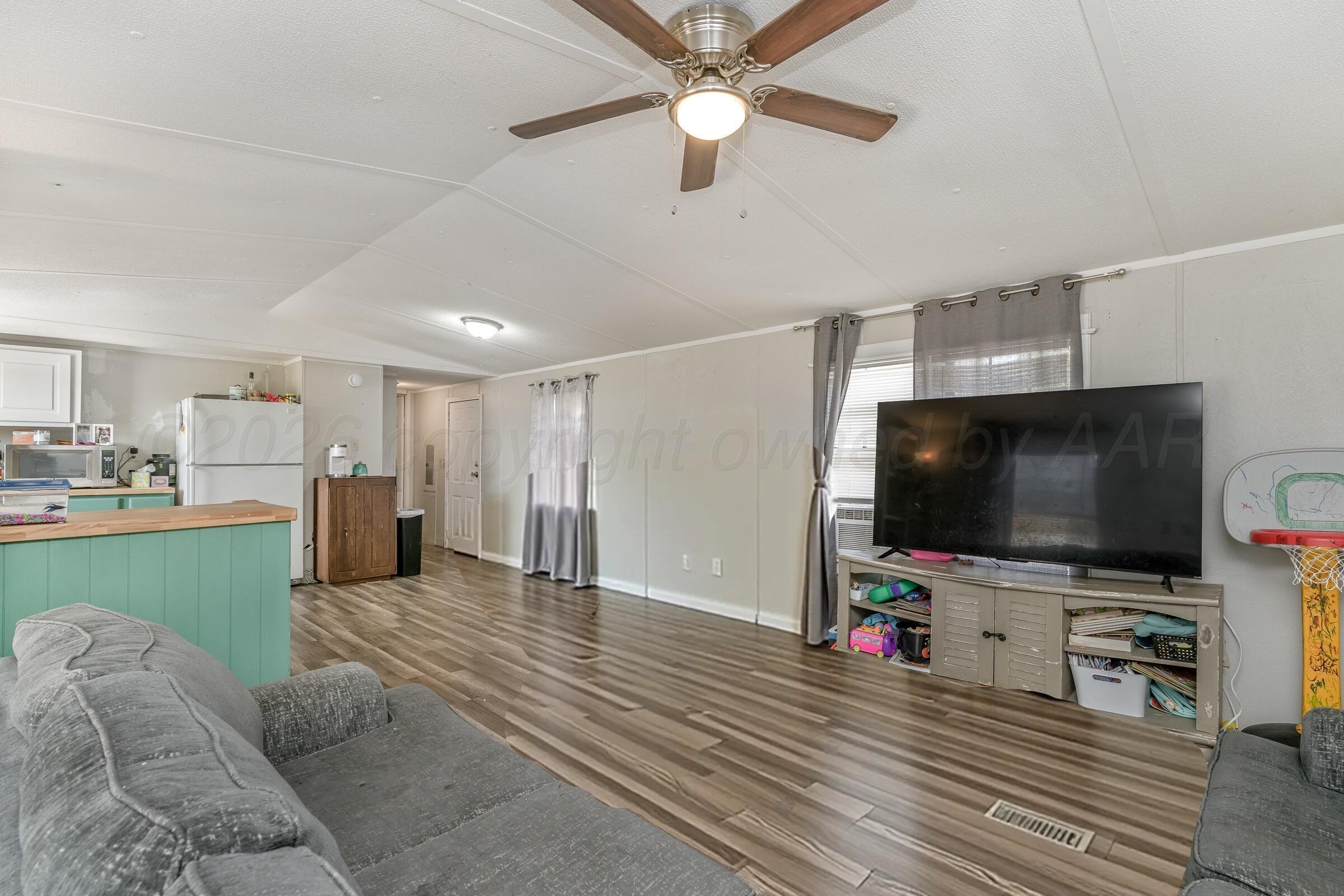 2115 Country Lane Amarillo, TX 79118 - Photo 5 of 15 a view of a livingroom with furniture and a flat screen tv
