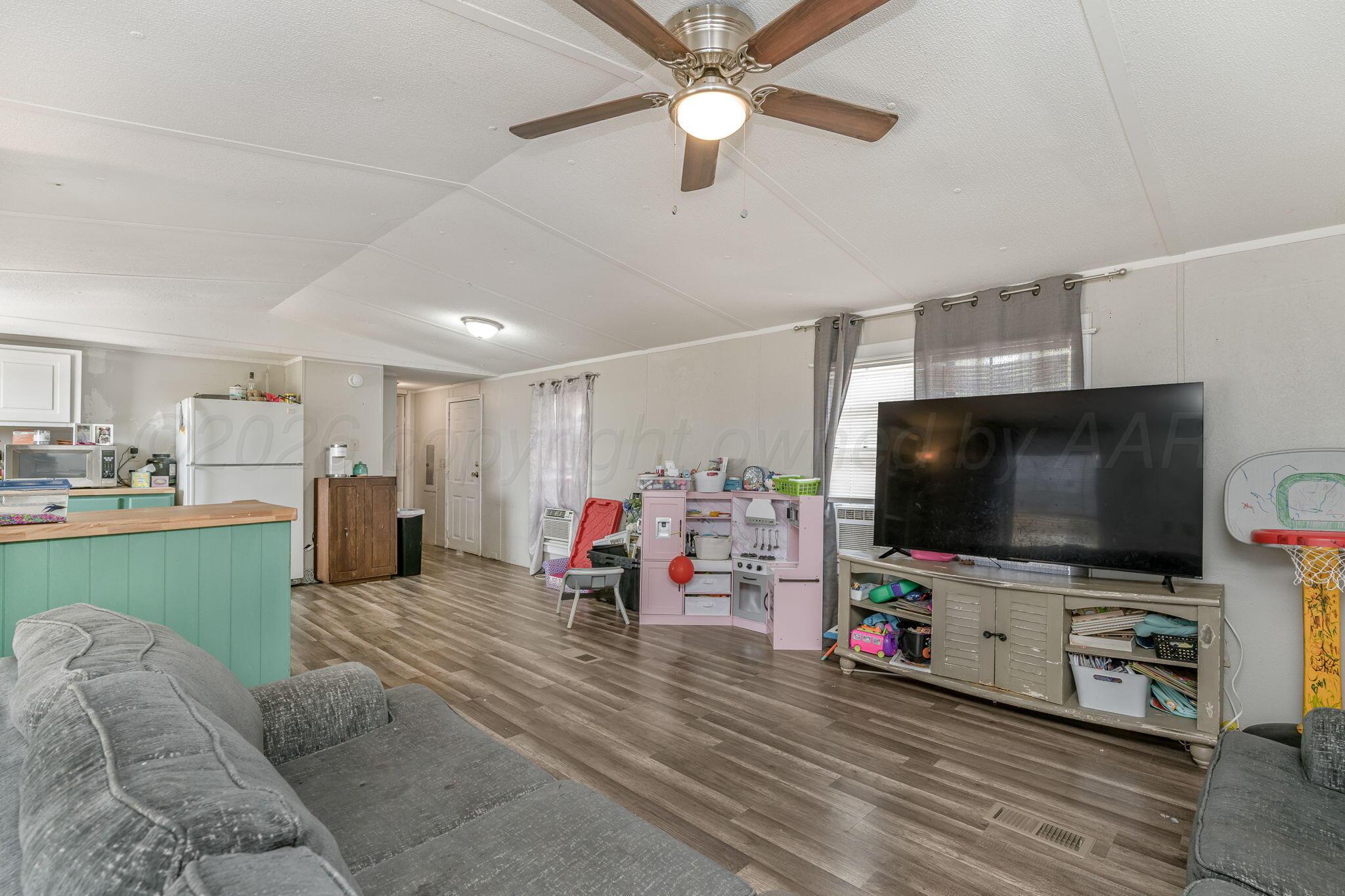 2115 Country Lane Amarillo, TX 79118 - Photo 7 of 15 a living room with furniture and a flat screen tv