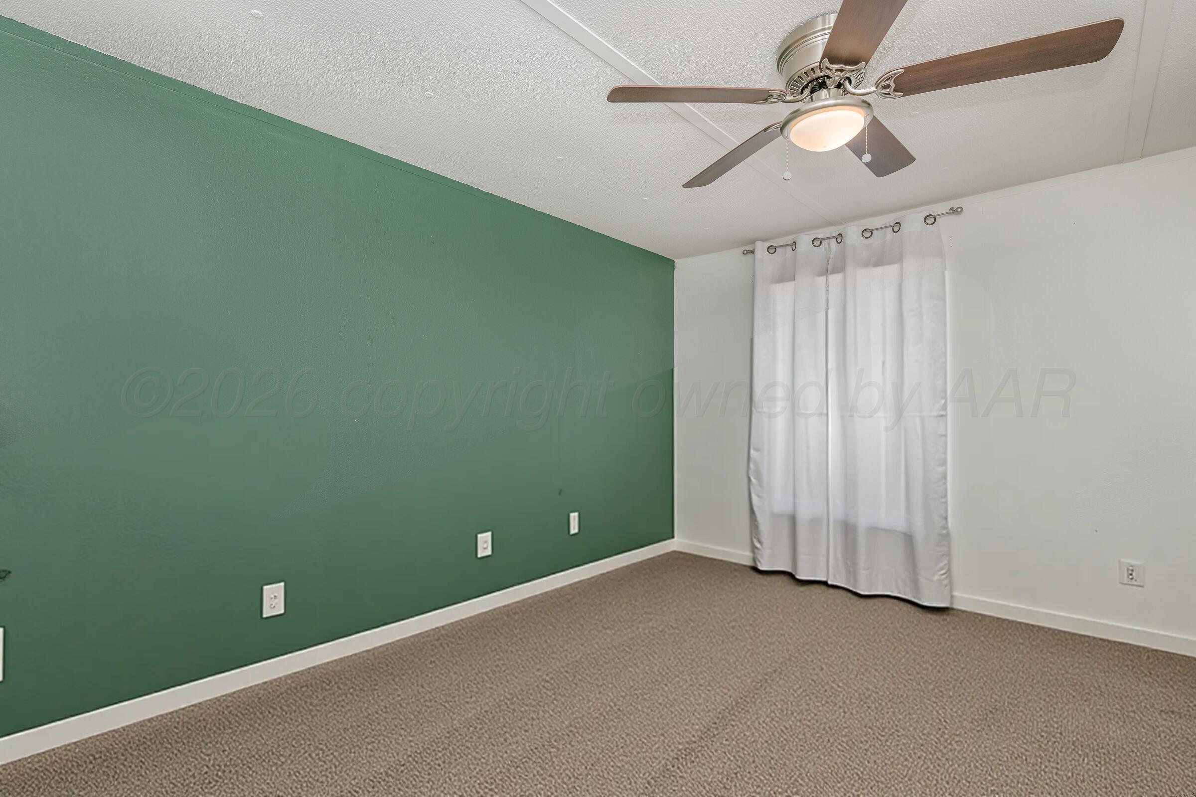 2115 Country Lane Amarillo, TX 79118 - Photo 8 of 15 an empty room with a ceiling fan and fan