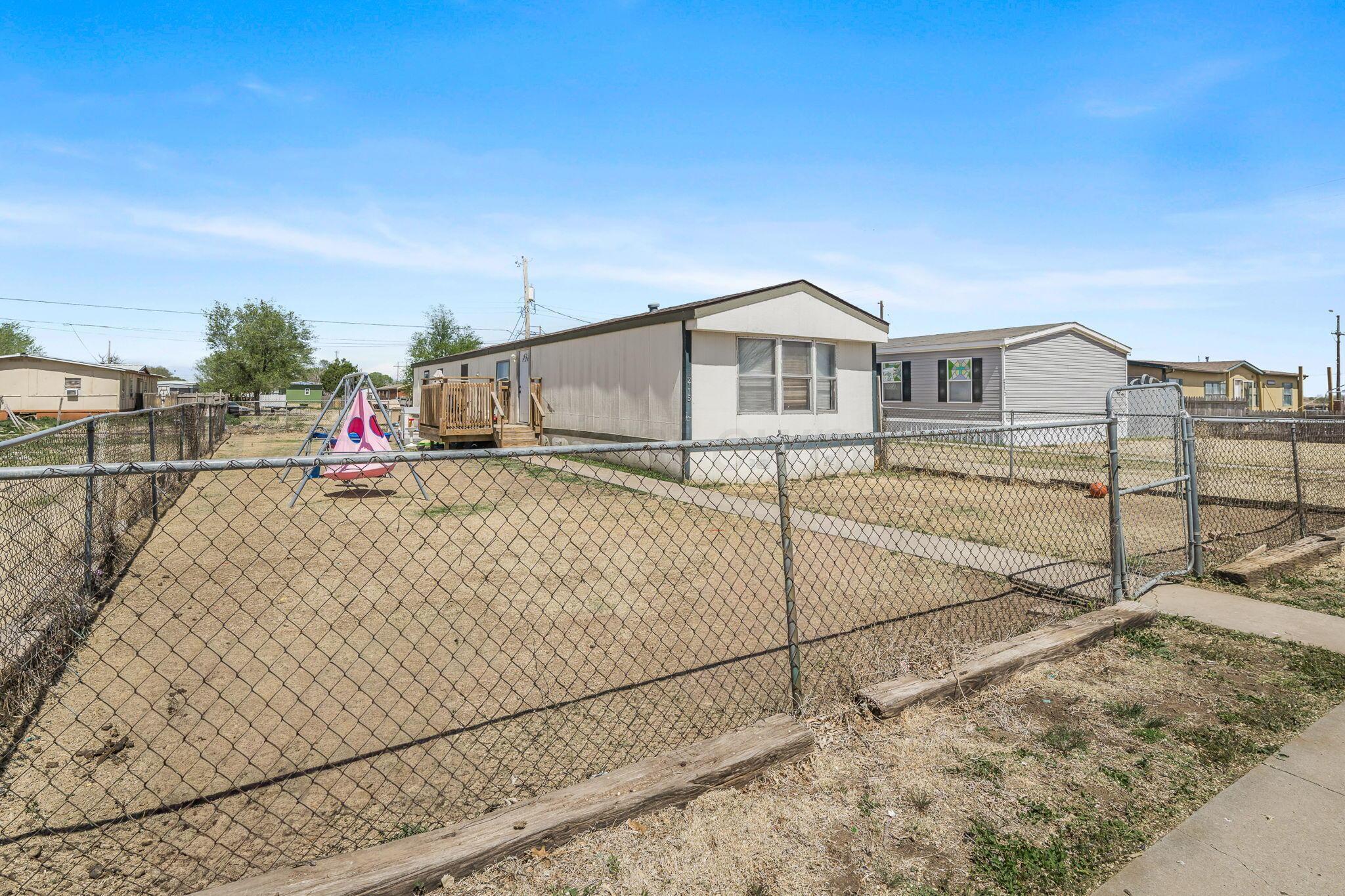 2115 Country Lane Amarillo, TX 79118 - Photo 9 of 15 a view of a house with a wooden fence