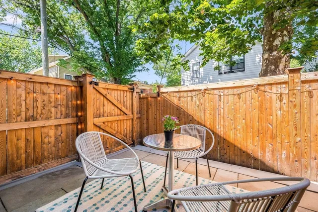 a balcony with table and chairs
