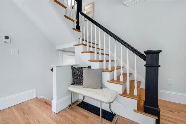 a view of entryway and hall with wooden floor