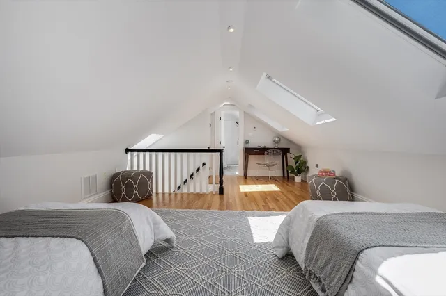 a view of a workspace with furniture and wooden floor