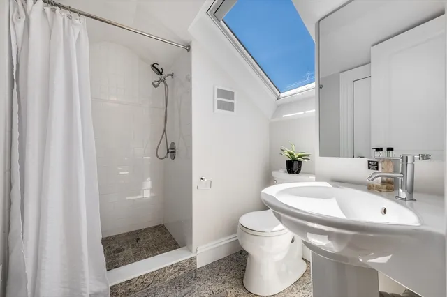 a bathroom with a sink toilet and shower