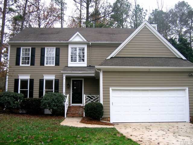 a view of a yard in front view of a house