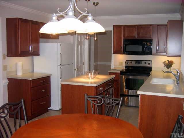 1421 Bridgeport Drive Raleigh, NC 27615 - Photo 4 of 10 a kitchen with a sink a stove and a microwave