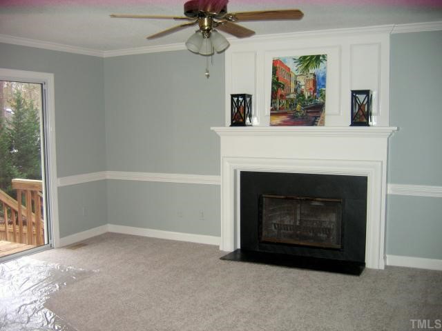 1421 Bridgeport Drive Raleigh, NC 27615 - Photo 5 of 10 a living room with a fireplace and a chandelier