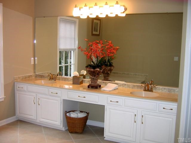 1421 Bridgeport Drive Raleigh, NC 27615 - Photo 6 of 10 a bathroom with a sink double vanity and a mirror