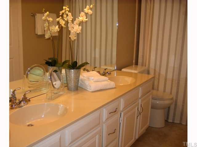 1421 Bridgeport Drive Raleigh, NC 27615 - Photo 7 of 10 a bathroom with a sink and a mirror