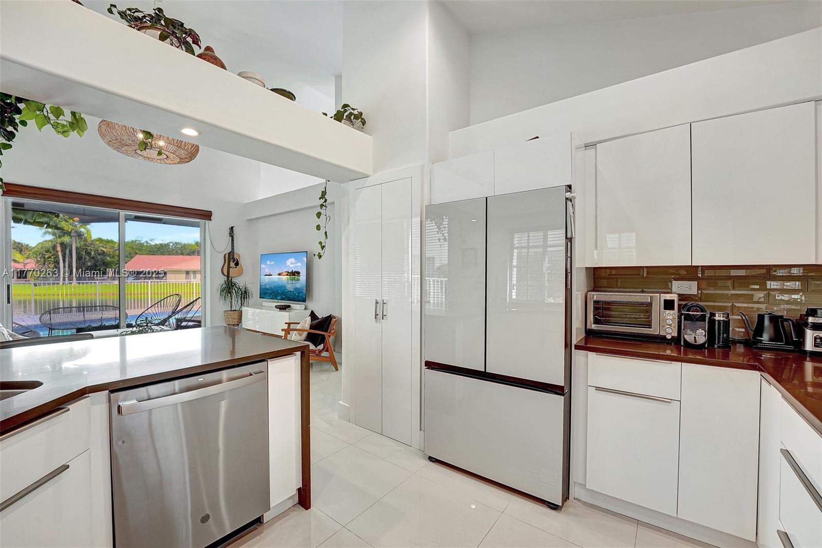 1055 San Luis Rey Weston, FL 33326 - Photo 27 of 75 a kitchen with stainless steel appliances a refrigerator and a sink