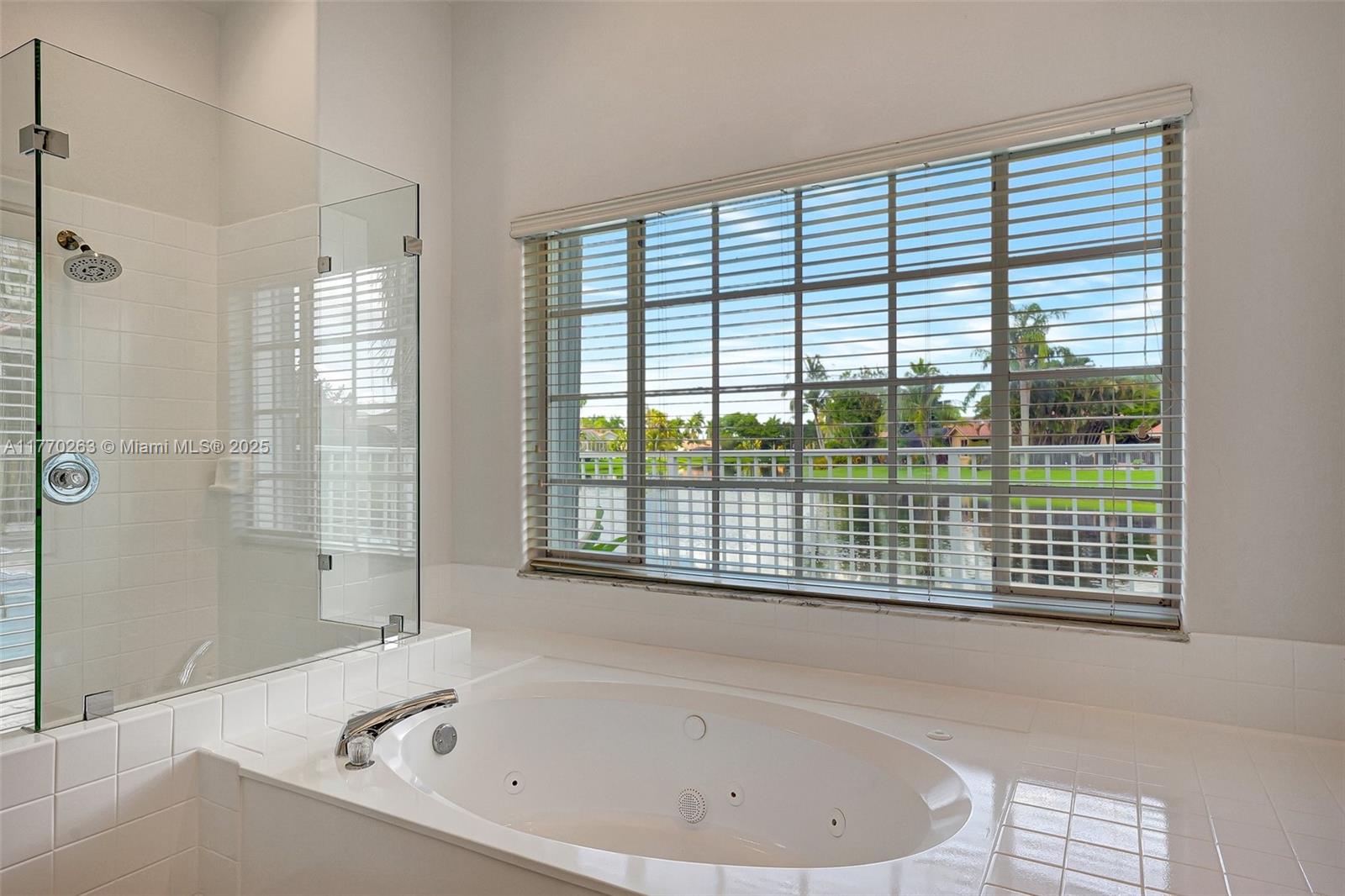 1055 San Luis Rey Weston, FL 33326 - Photo 33 of 75 a bathroom with a bathtub and next to a window