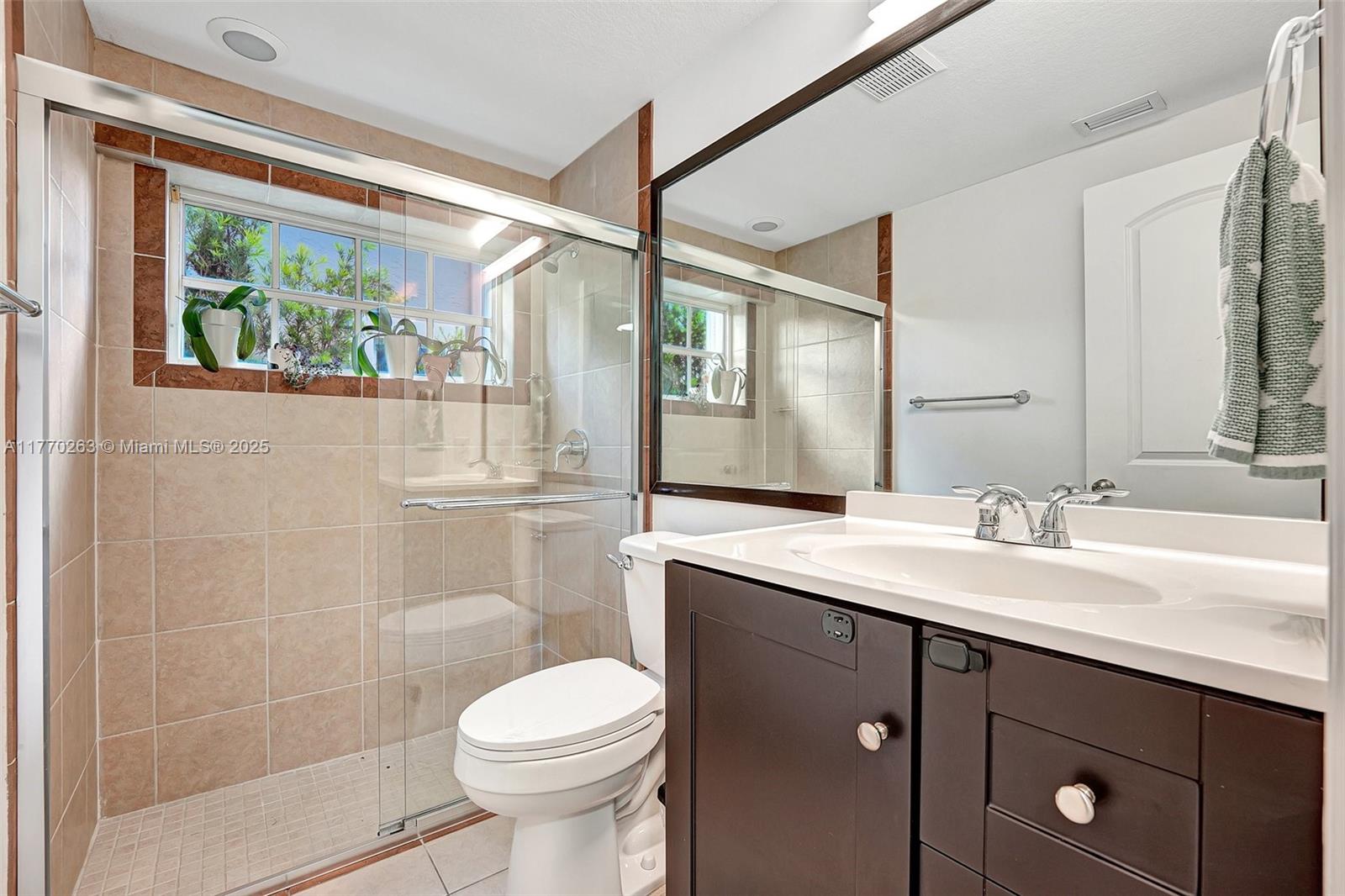 1055 San Luis Rey Weston, FL 33326 - Photo 34 of 75 a bathroom with a sink and a mirror