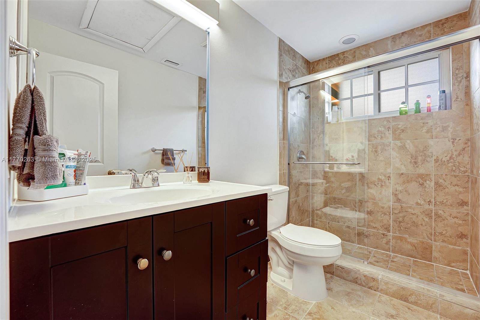 1055 San Luis Rey Weston, FL 33326 - Photo 45 of 75 a bathroom with a sink a toilet and shower