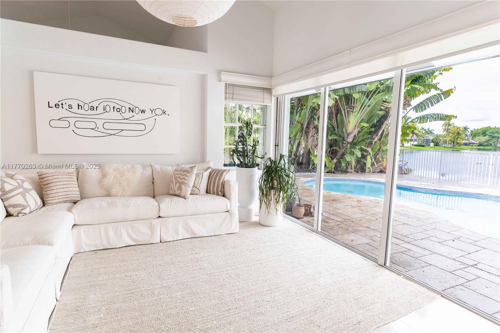 1055 San Luis Rey Weston, FL 33326 - Photo 46 of 75 a living room with a large window couch and table in it