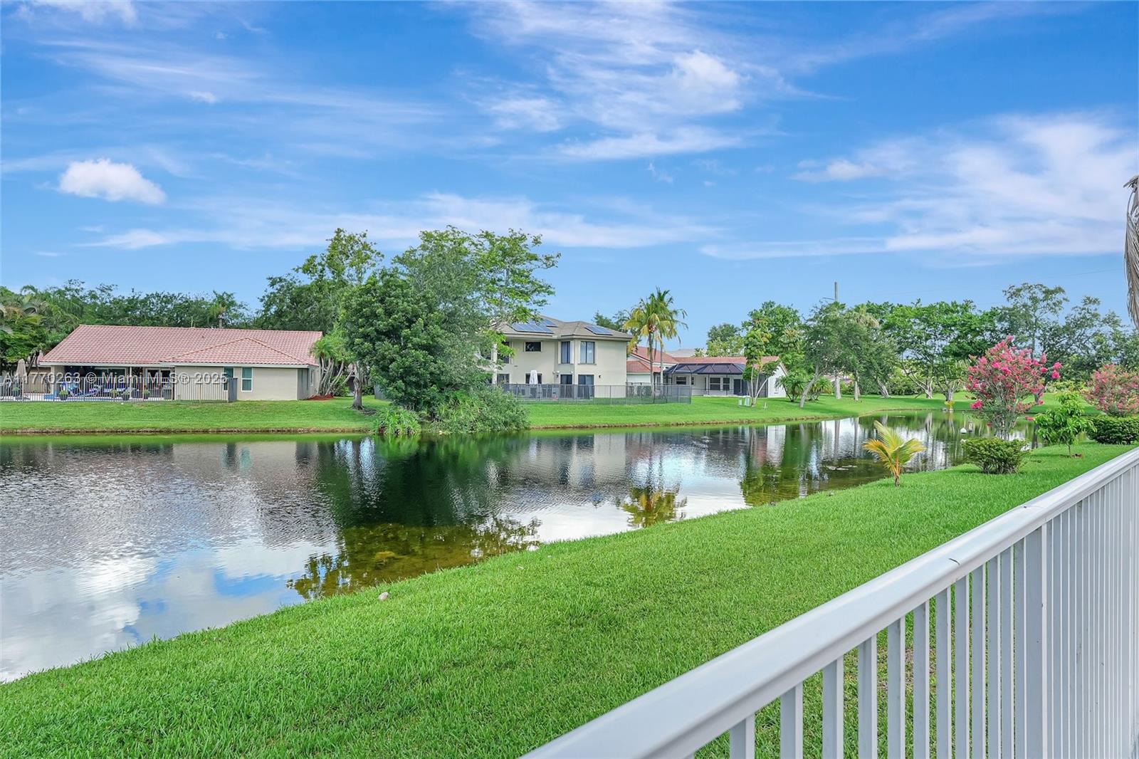1055 San Luis Rey Weston, FL 33326 - Photo 51 of 75 a view of a lake with a house in the background