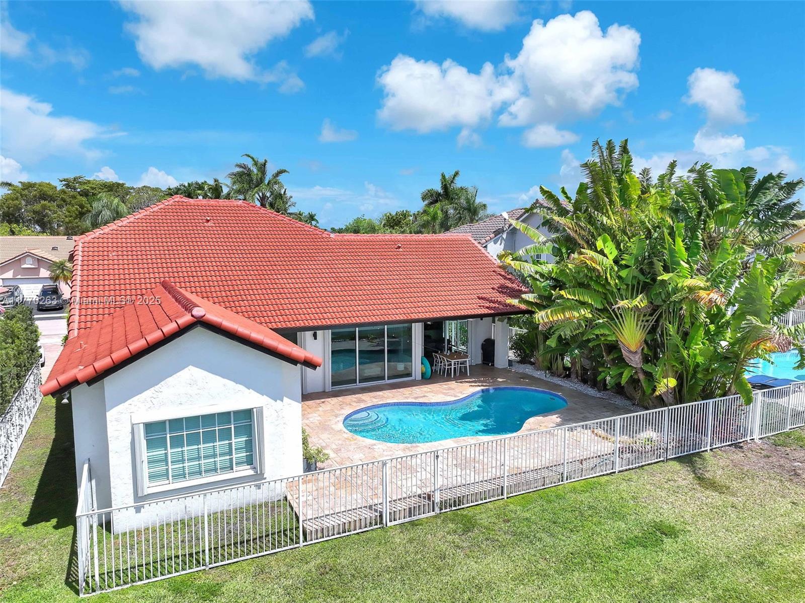 1055 San Luis Rey Weston, FL 33326 - Photo 70 of 75 a front view of a house with a yard
