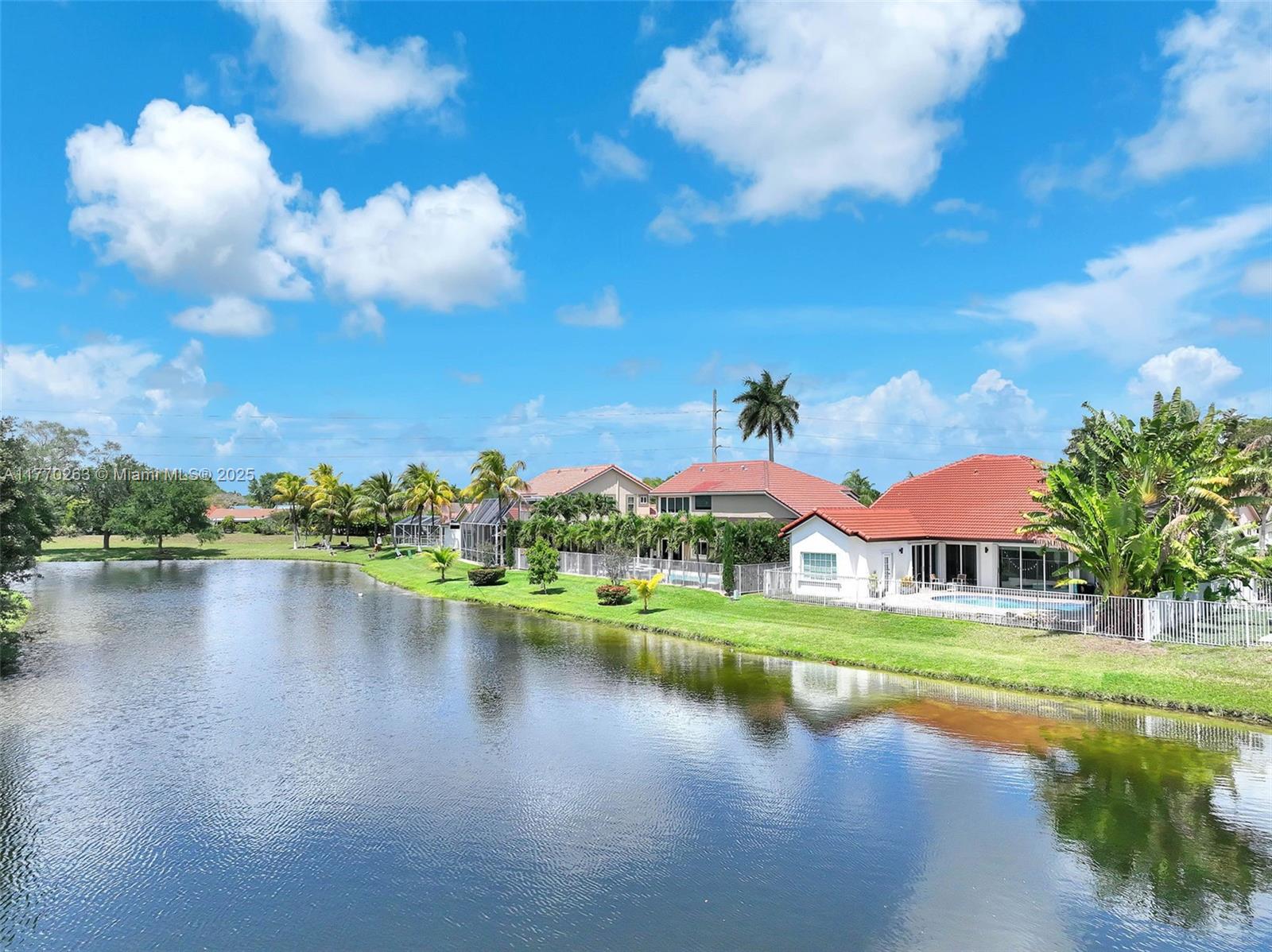 1055 San Luis Rey Weston, FL 33326 - Photo 71 of 75 an aerial view of residential houses with outdoor space and lake view