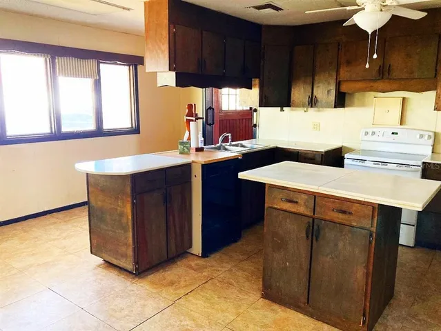 a kitchen with stainless steel appliances granite countertop a sink counter space cabinets and a counter top space