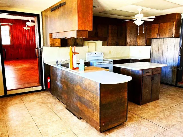 a view of an empty room with a fireplace and a window