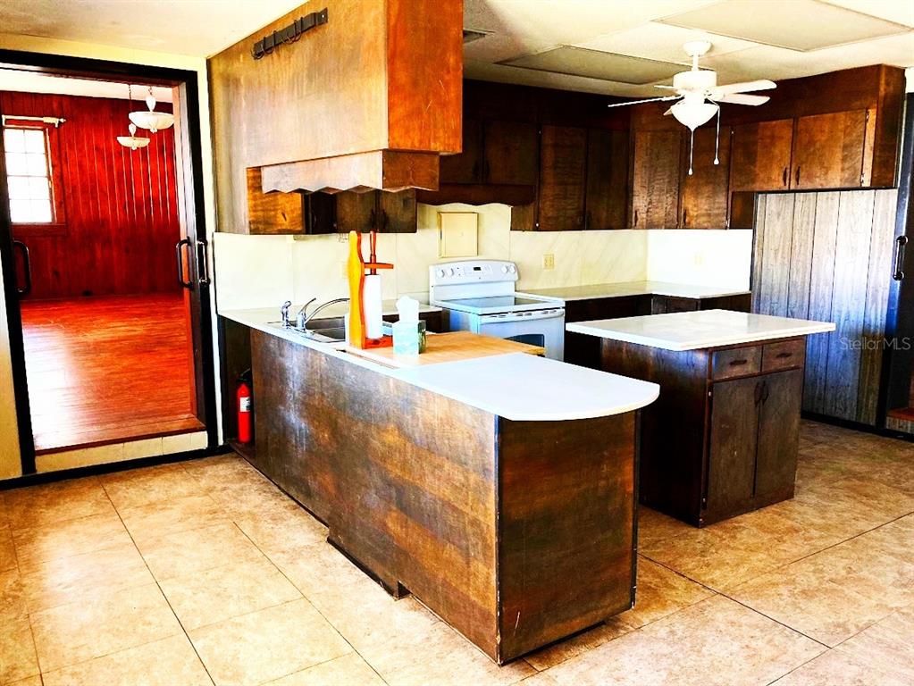 125 Southwest 6th Street Lake Butler, FL 32054 - Photo 17 of 23 a kitchen with stainless steel appliances granite countertop a sink counter space cabinets and a counter top space