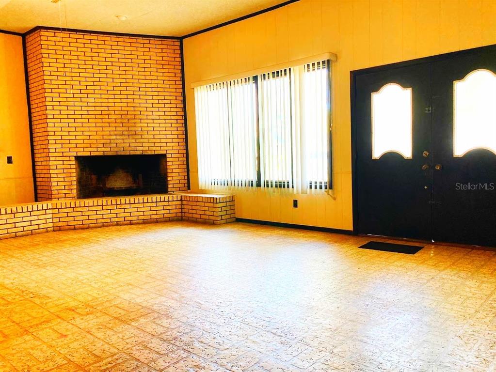 125 Southwest 6th Street Lake Butler, FL 32054 - Photo 18 of 23 a view of an empty room with a fireplace and a window