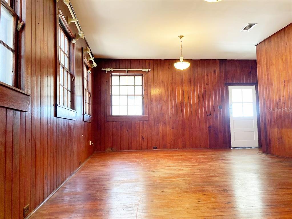 125 Southwest 6th Street Lake Butler, FL 32054 - Photo 3 of 23 an empty room with wooden floor and windows