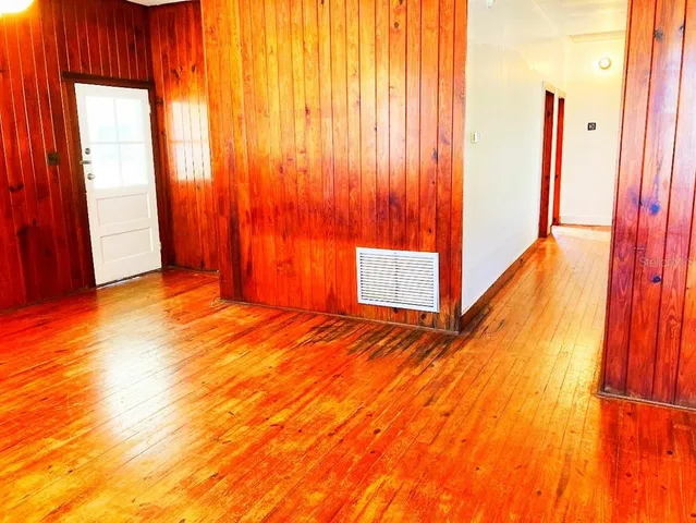 a view of a room with wooden floor and chair