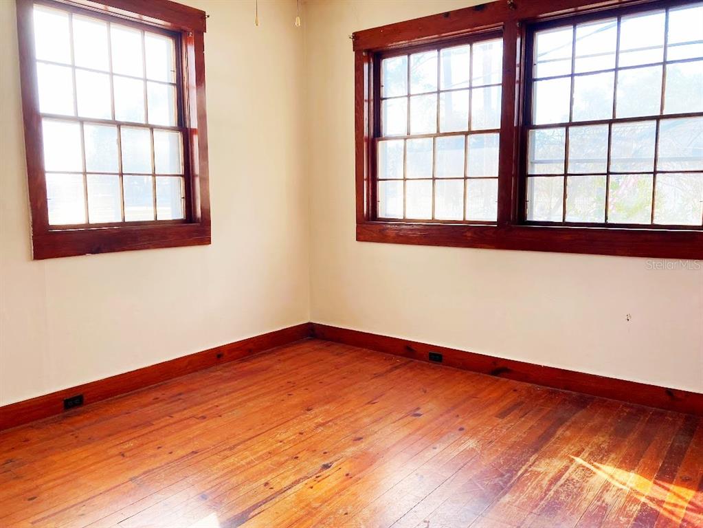 125 Southwest 6th Street Lake Butler, FL 32054 - Photo 6 of 23 an empty room with wooden floor and windows