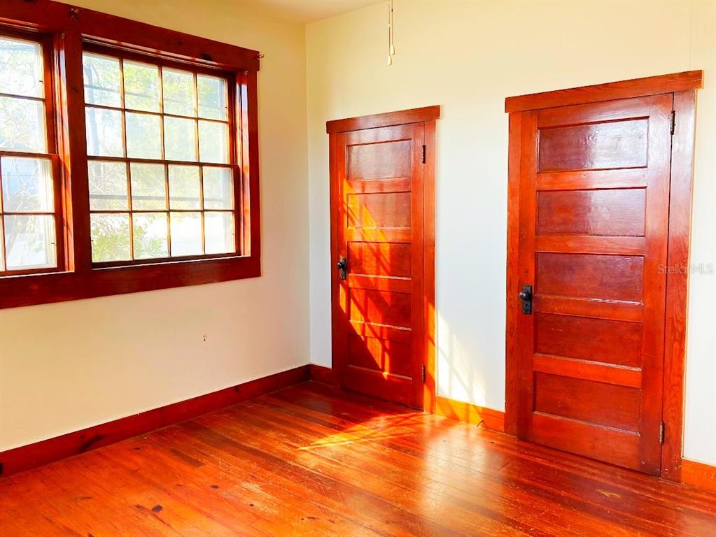 125 Southwest 6th Street Lake Butler, FL 32054 - Photo 7 of 23 an empty room with wooden floor and windows