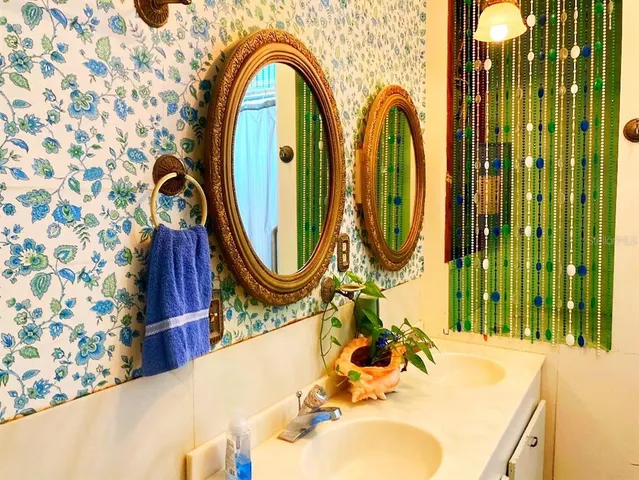 a bathroom with a sink a mirror and a shower curtain