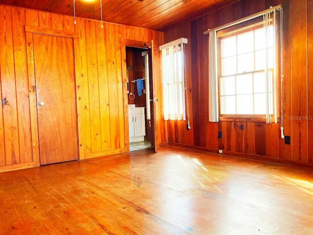 an empty room with a window and a bathtub