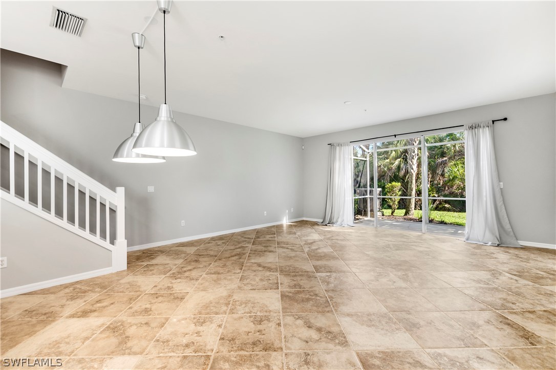 15633 Marcello Circle, Unit 133 Naples, FL 34110 - Photo 2 of 23 a view of an empty room with a window