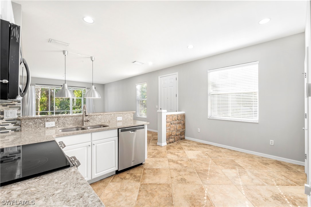 15633 Marcello Circle, Unit 133 Naples, FL 34110 - Photo 7 of 23 a large white kitchen with a large window