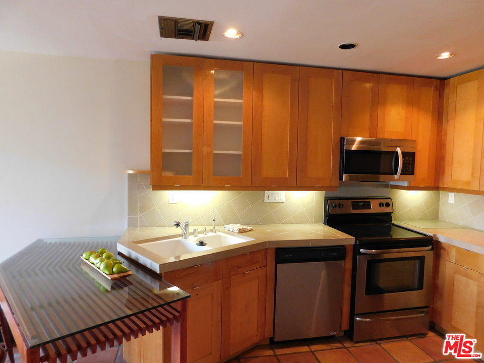 740 North Kings Road, Unit 201 Los Angeles, CA 90069 - Photo 1 of 20 a kitchen with a sink appliances and cabinets