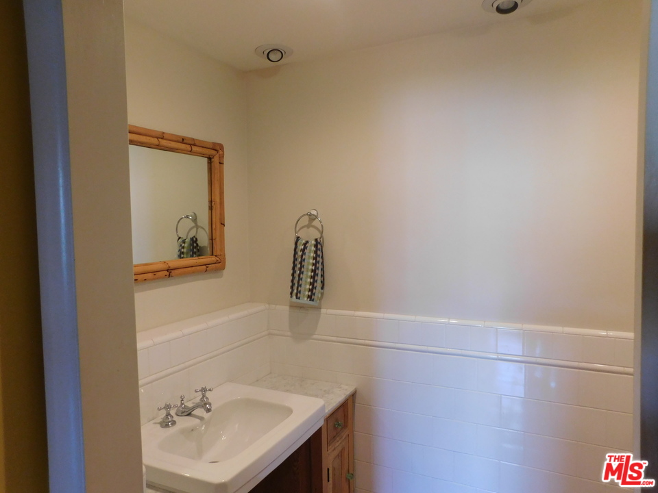 740 North Kings Road, Unit 201 Los Angeles, CA 90069 - Photo 12 of 20 a bathroom with a sink and mirror