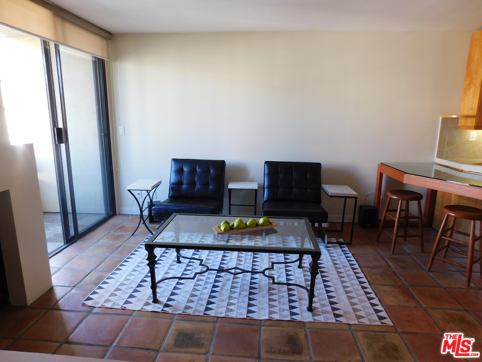 740 North Kings Road, Unit 201 Los Angeles, CA 90069 - Photo 15 of 20 a living room with furniture and a rug