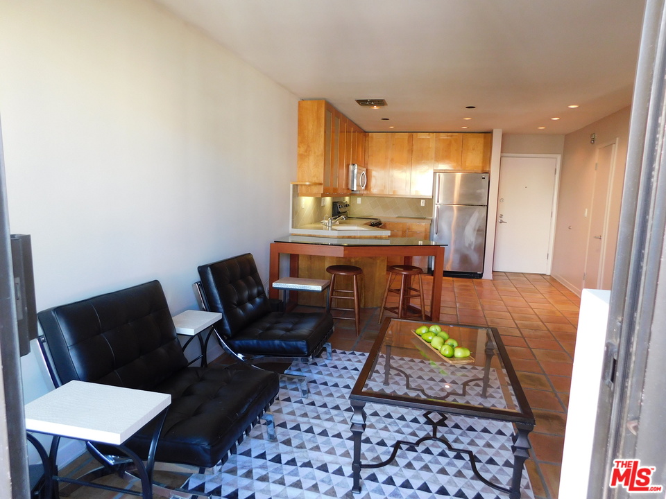 740 North Kings Road, Unit 201 Los Angeles, CA 90069 - Photo 16 of 20 a room with furniture and a table