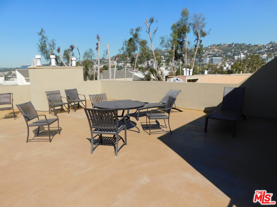 740 North Kings Road, Unit 201 Los Angeles, CA 90069 - Photo 18 of 20 a view of a terrace with furniture and a fire pit